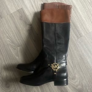Michael Kors black riding boots with brown trip at top.